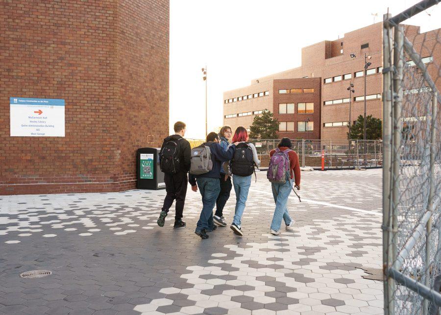 UMass Boston students walk between Campus Center and McCormack Hall after a club meeting.