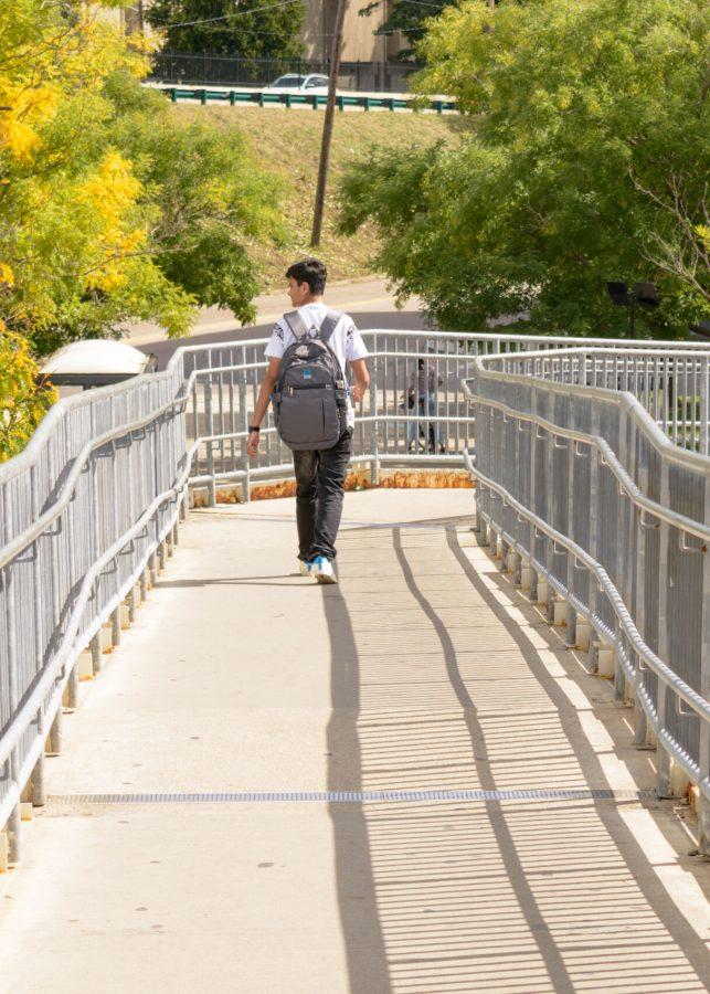 A student walks down the ramp of the JFK/UMass MBTA Station.