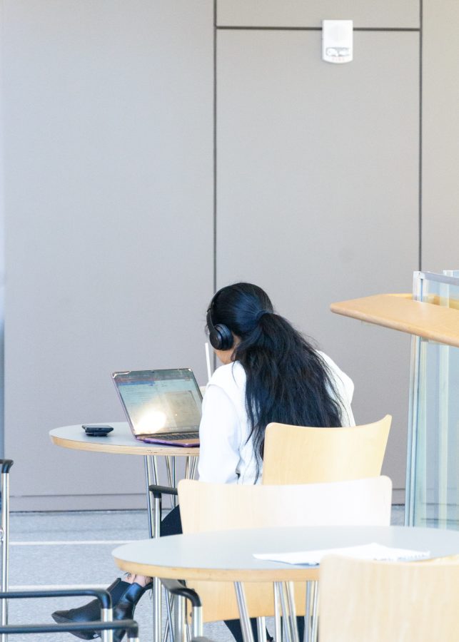 A student catches up on some new music as she does some homework in UMass Boston’s Integrated Sciences Complex.