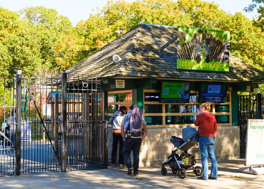 People stand near the entrance to the Franklin Park Zoo in Boston.