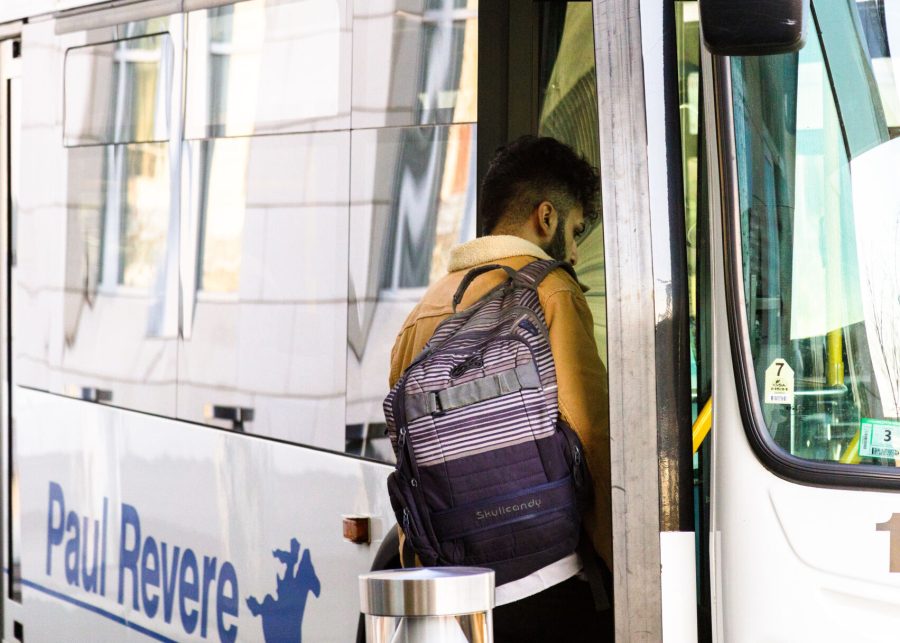 A student enters the #1 shuttle at UMass Boston’s Campus Center.
