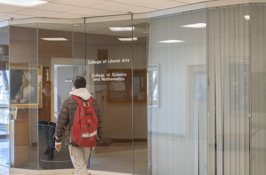 Students passing by the CLA Deans office in Wheatley. Photo by Hunter Berry (He/Him) / Mass Media Staff. 