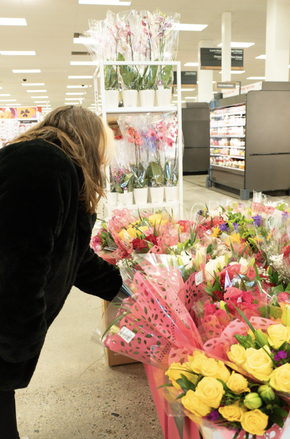 Emelia shops for some flowers at a local store in time for Valentines Day. Photo by Olivia Reid (She/Her) / Photography Editor. 