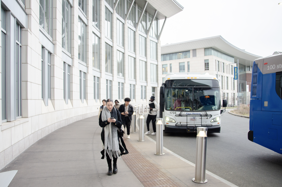 UMass Boston students get off the shuttle bus at the Campus Center. Photo by Saichand Chowdary (He/Him) / Mass Media Staff.