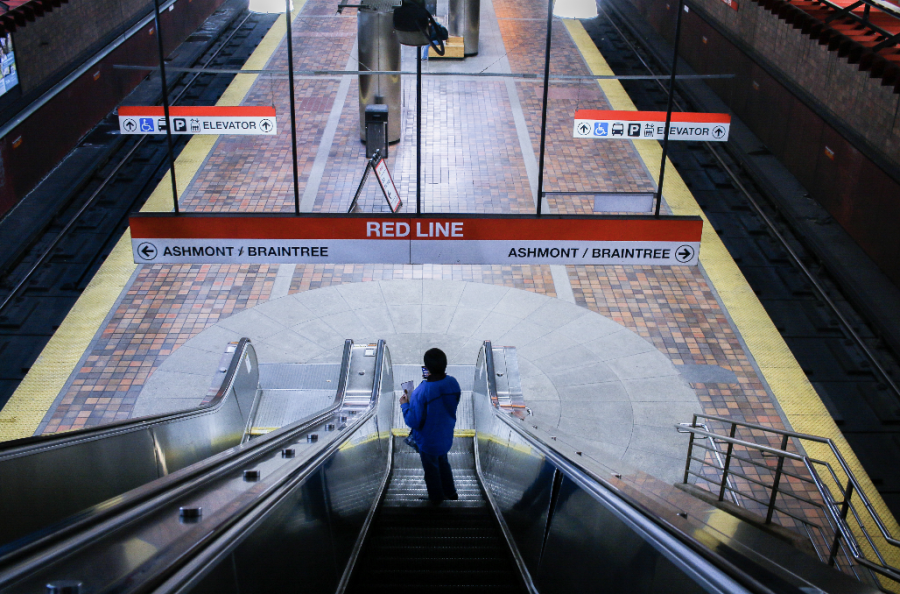 A commuter waits for their Red Line train. Photo by Colin Tsuboi (He/Him) / Mass Media Contributor.
