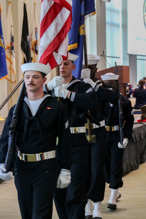 The color guard from the U.S.S. Constitution parades out off the main deck after presenting the colors. Photo by Colin Tsuboi (He/Him) / Mass Media Contributor.