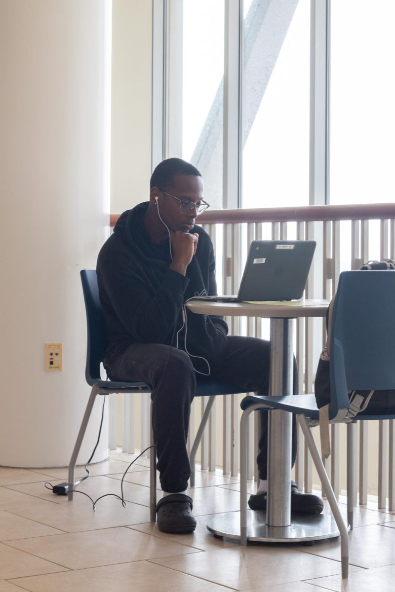 In the Campus Center, a student finds a new study spot on campus. Photo by Colin Tsuboi / Mass Media Staff.