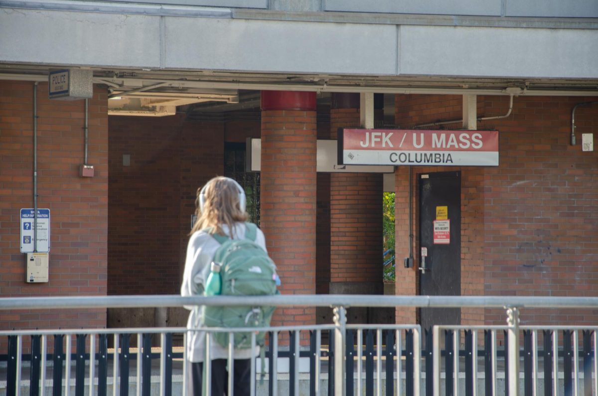 A student waits for a Red Line train at JFK/UMass station for their commute home. Photo by Photo by Saichand Chowdary / Mass Media Staff.