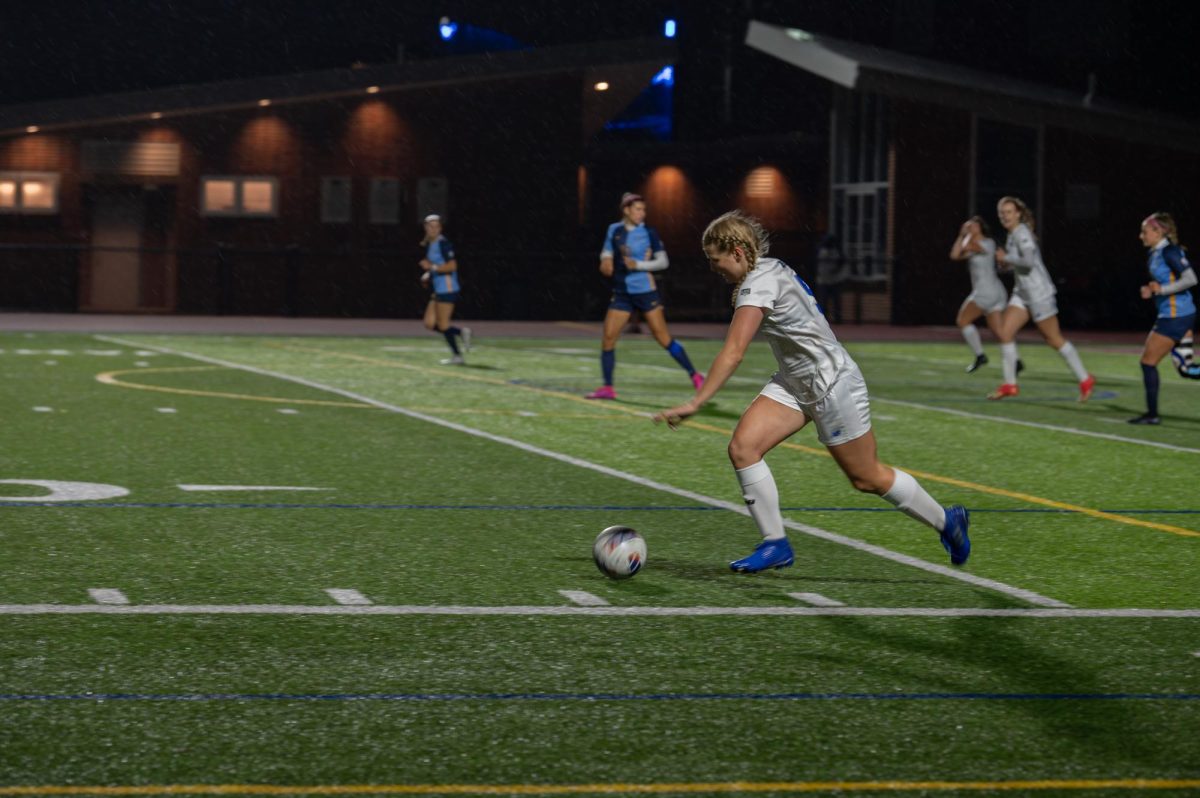 A women’s soccer player guides the ball to the net during a previous home game. Photo by Olivia Reid / Photography Editor.