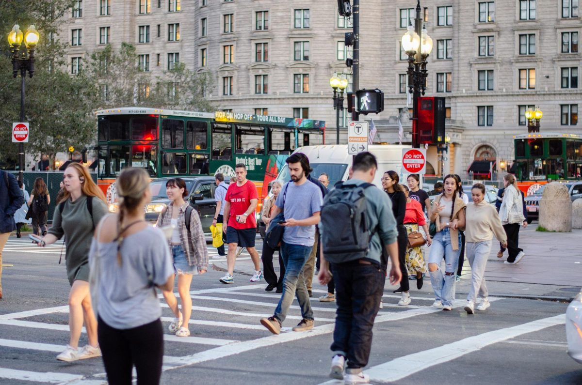 A group of people cross the street near Copley Square. Photo by Saichand Chowdary / Mass Media Staff.