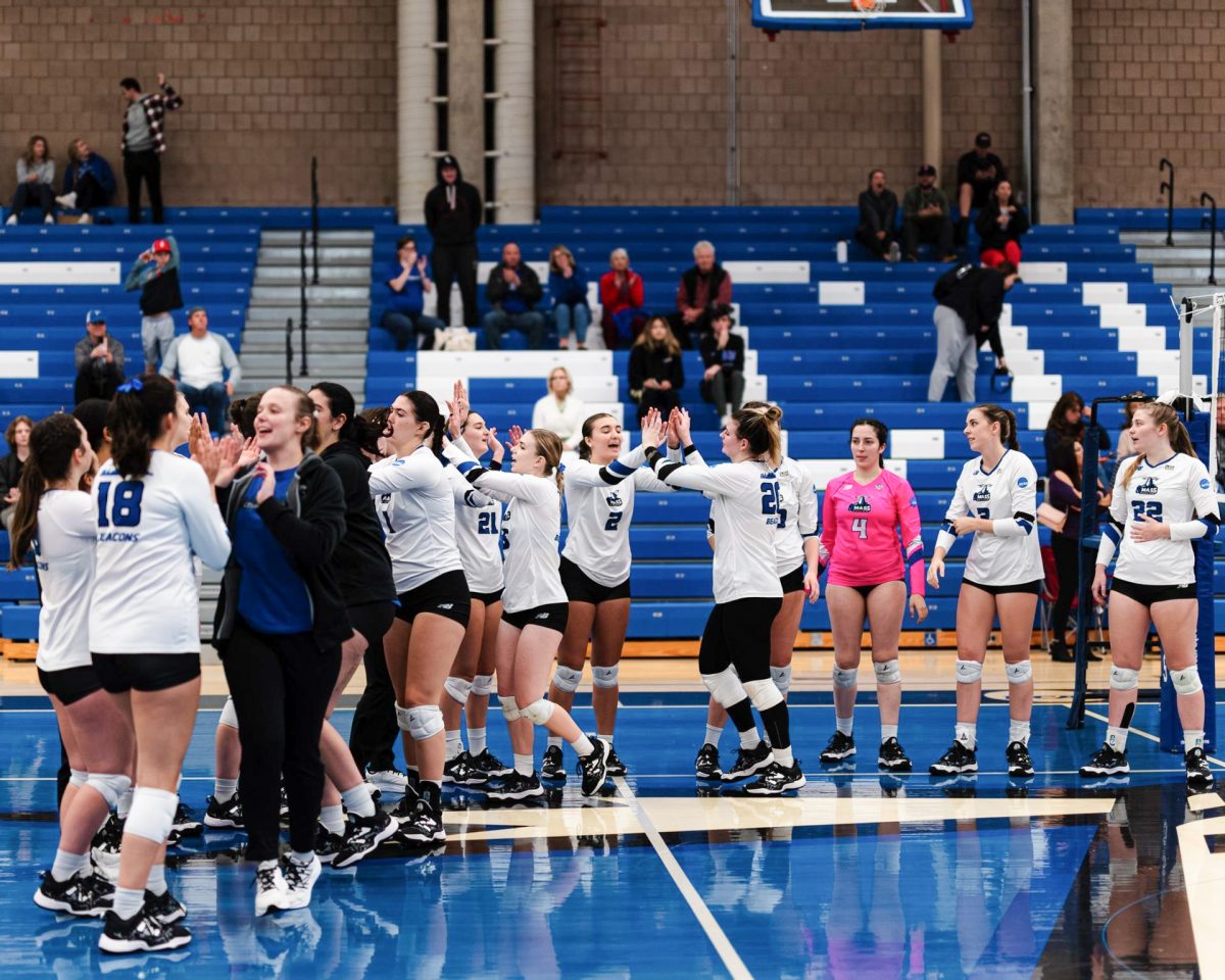 UMass Boston Women’s Volleyball team prepares for a home game. Photo by Salt Lake Photo Company / Beacons Athletics.