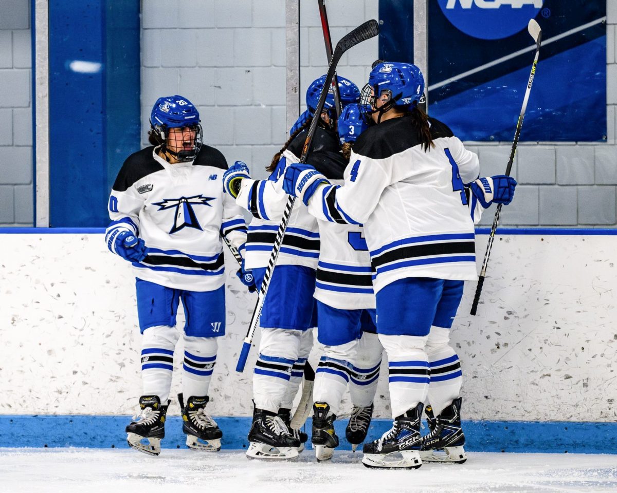 Women%E2%80%99s+hockey+players+celebrate+after+a+goal+during+a+previous+home+game.+Photo+provided+by+Beacons+Athletics.