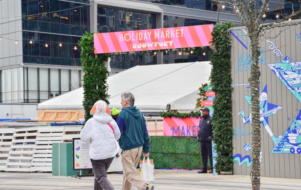 People walk around Seaport District passing the Snowport Holiday Market. Photo by Saichand Chowdary/ Mass Media Staff.