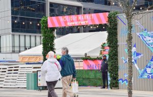 People walk around Seaport District passing the Snowport Holiday Market. 