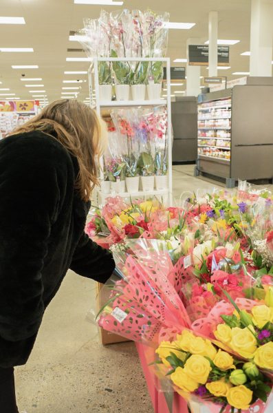 A customer looks through flowers at Target. Photo by Olivia Reid / Photography Editor.