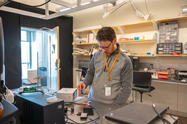 UMass Boston Professor Johnathan Celli gets to work in his lab. Photo by Olivia Reid / Photography Editor.
