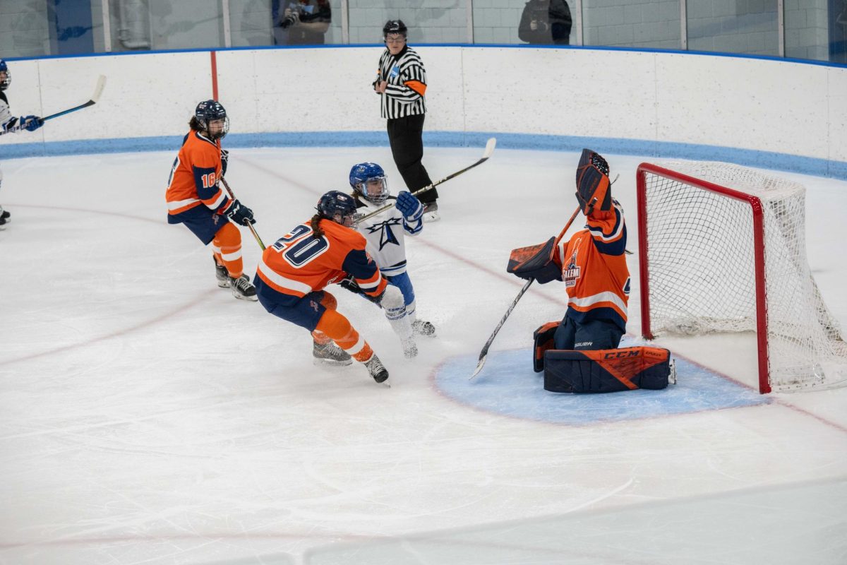 Forward Katie Wilbert shoots the puck against Salem State University at a home game on Jan. 26. Photo by Dong Woo Im / Mass Media Staff.