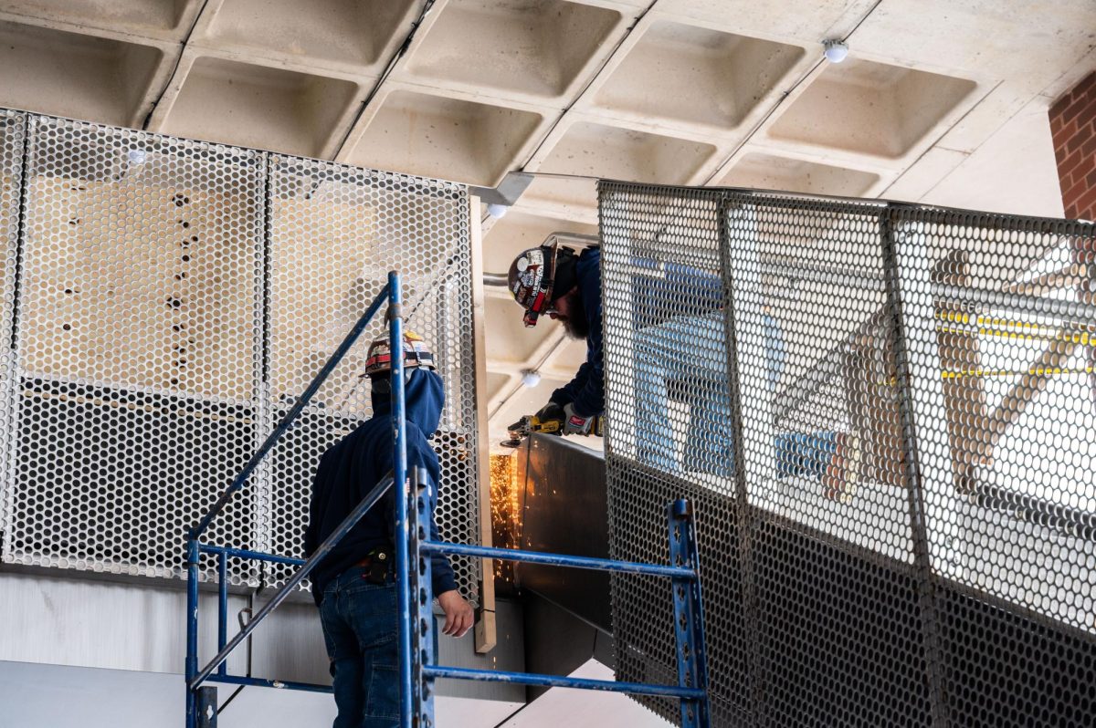 Construction workers build the stairs outside of Healey Library. Photo by Olivia Reid / Photography Editor.