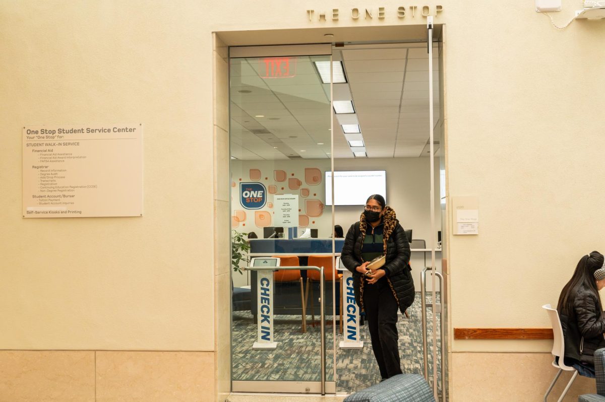 A student leaves The One Stop, a student services center located on the Upper Level of the Campus Center. Photo by Olivia Reid / Photography Editor.