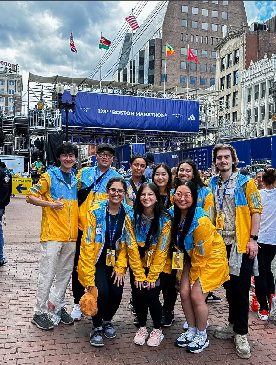 Members of UMass Boston’s DSP Chapter pose for a photo by the Boston Marathon finish line.