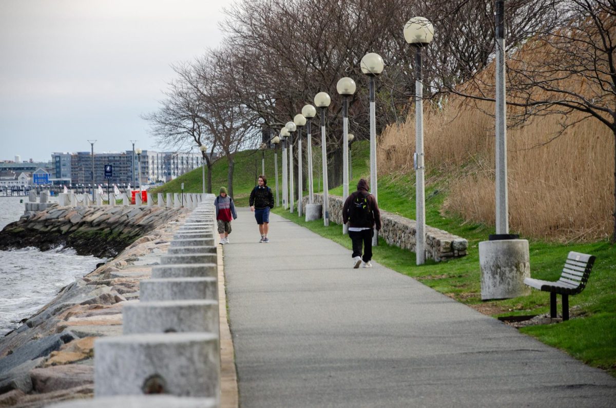 During the evening, students enjoy the Harbor Walk’s GRACE trail along the water. Photo by Saichand Chowdary / Mass Media Staff.