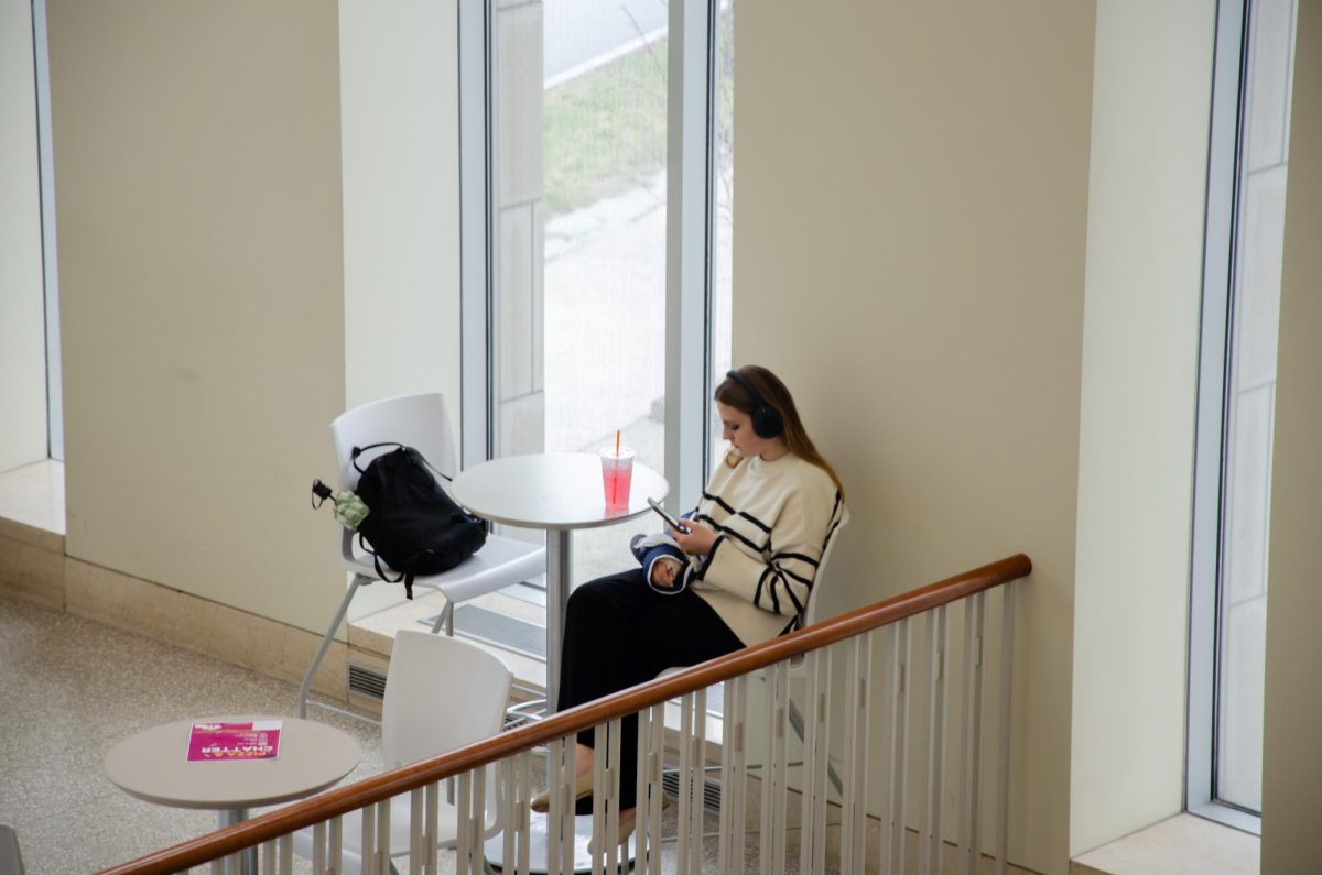 A student listens to music in the Campus Center in between classes. Photo by Saichand Chowdary / Mass Media Staff.