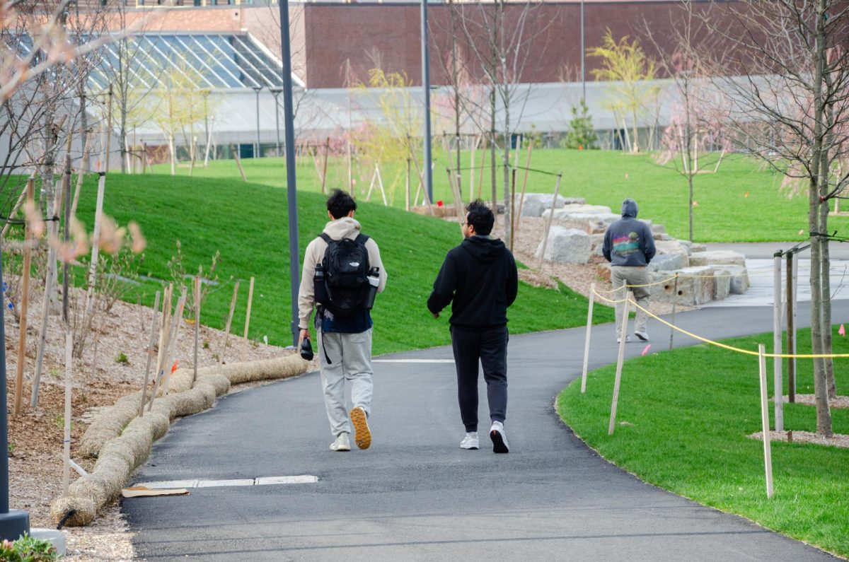 Students enjoy a walk through the newly opened campus quad. Photo by Saichand Chowdary / Mass Media Staff.