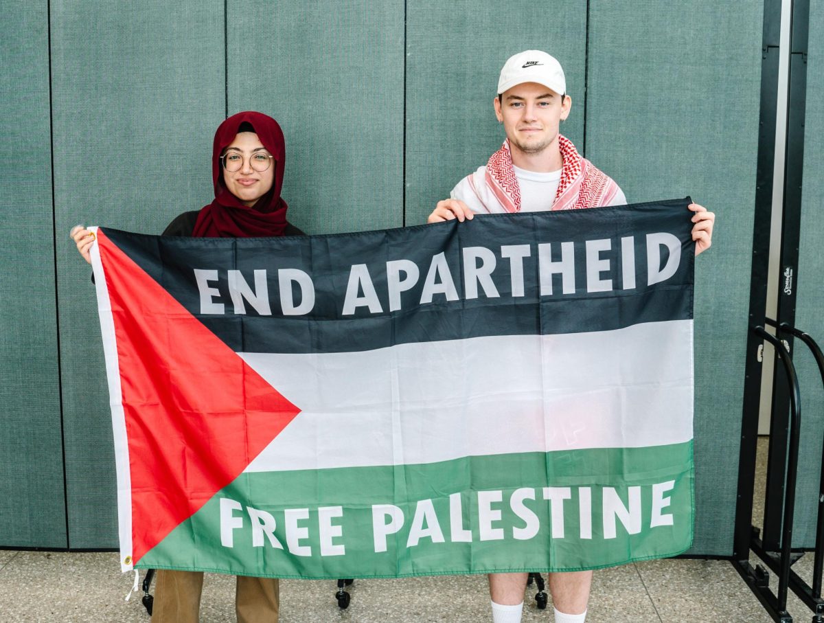 Two members of Students for Justice in Palestine hold a Free Palestine flag during educational events hosted by the club for Israeli Apartheid Week. Photo by Olivia Reid / Photography Editor