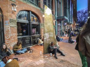 Students at Emerson College's encampment for Palestine last spring sit and talk outside a campus building.