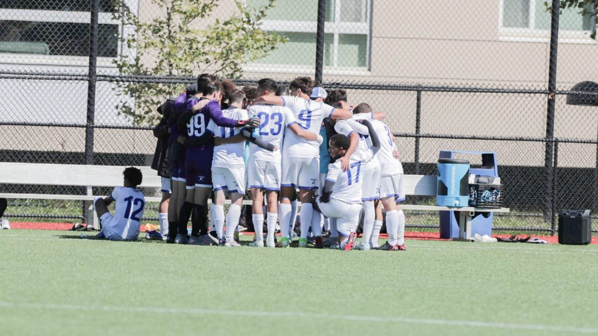 Beacons huddle together during a timeout last season. Photo by Olivia Reid/ Photography Editor.