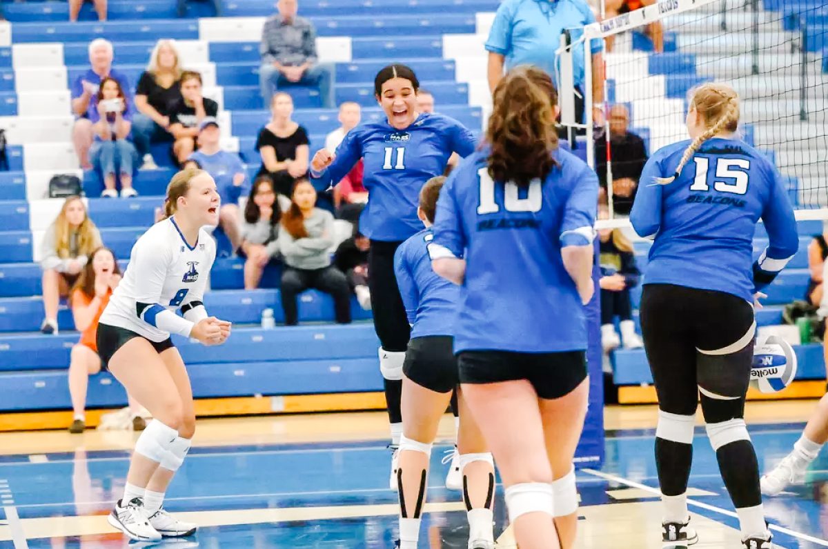 The women's volleyball team cheers after a win on Sept. 11. Photo from Beacon Athletics. 