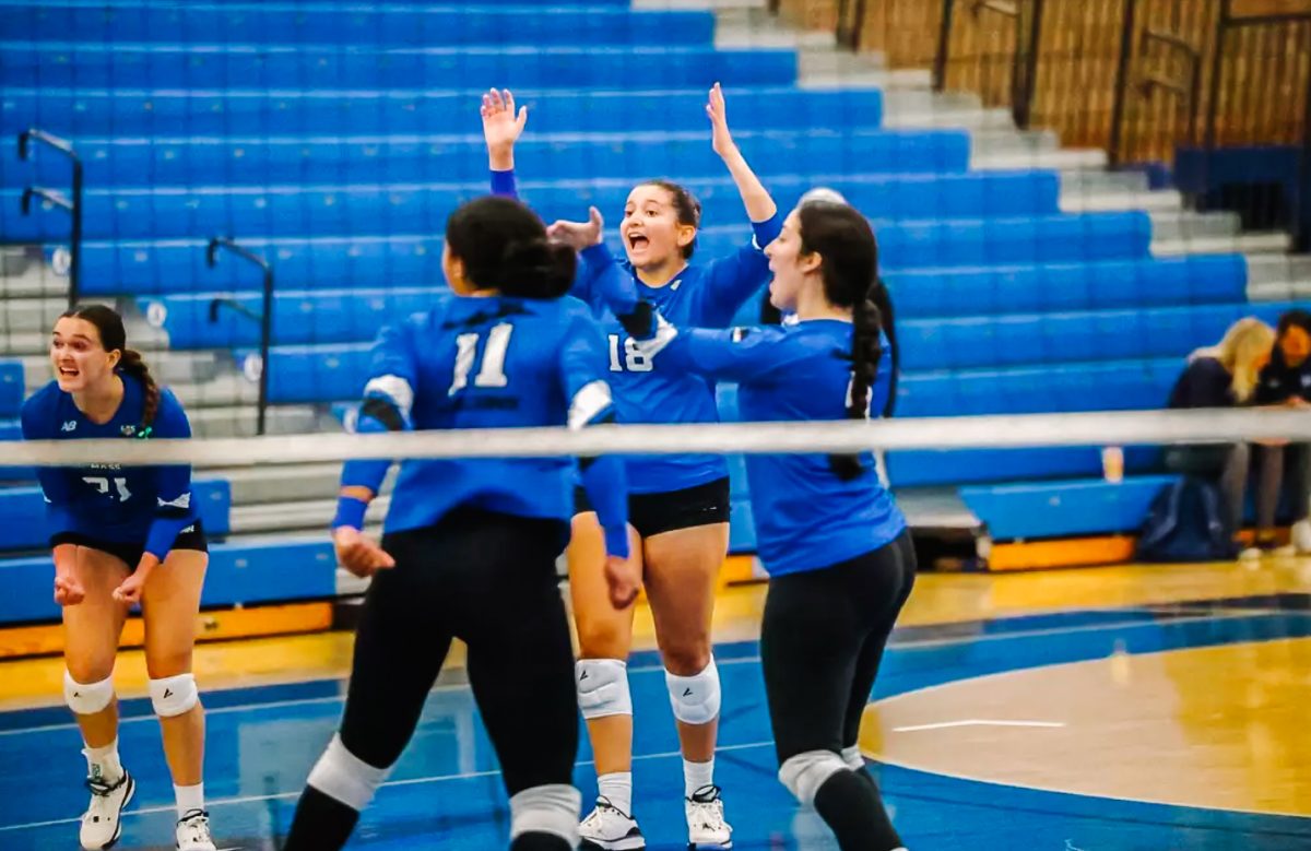 The women's volleyball team cheers after a win on Sept. 11. Photo from Beacon Athletics. 