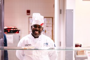 Executive Chef Jocelyn Aurelien smiles for a portrait in the Dining Commons.