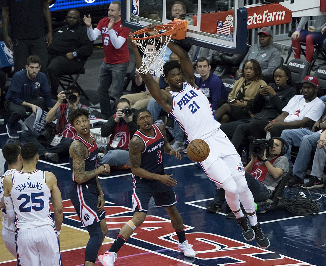 Joel Embiid, Number 21, at a game in 2018. Photo by Keith Allison licensed under CC BY-SA 2.0.