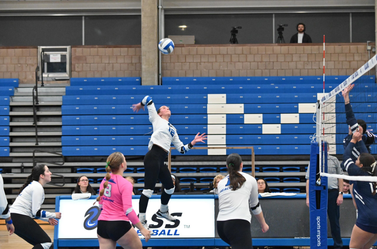 Lauren Westlund spikes the ball at the Beacons' final game.