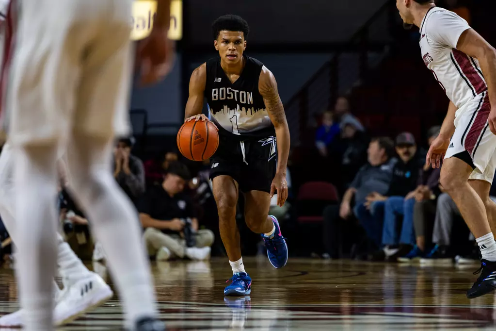 Beacons basketball player Xavier McKenzie runs up court at a game against UMass Amherst in December. Photo by Becky Schoenecker/ Beacon Athletics. 