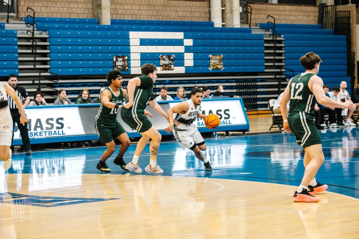 Emanuel Zayas runs up court, after becoming UMass Boston’s newest 1000 point scorer.