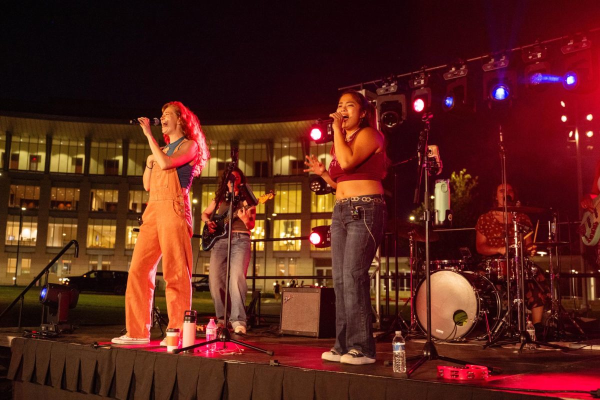 “The Femmes” lead singer Bailey Katsu (right) and vocalist Ellie Brigida (left), who are in a relationship, performed together at UMass Boston’s waterfront Fall Concert Sept. 5. Courtesy of Kaitlin Prince via UMass Boston