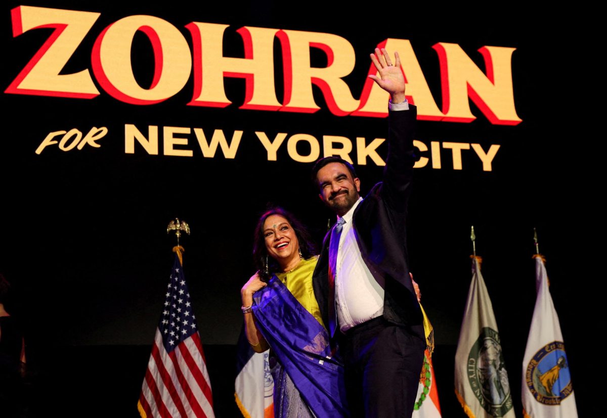 Democratic candidate for New York City mayor Zohran Mamdani waves next to his mother Mira Nair onstage after winning the 2025 New York City Mayoral race, at an election night rally in Brooklyn Nov. 4.