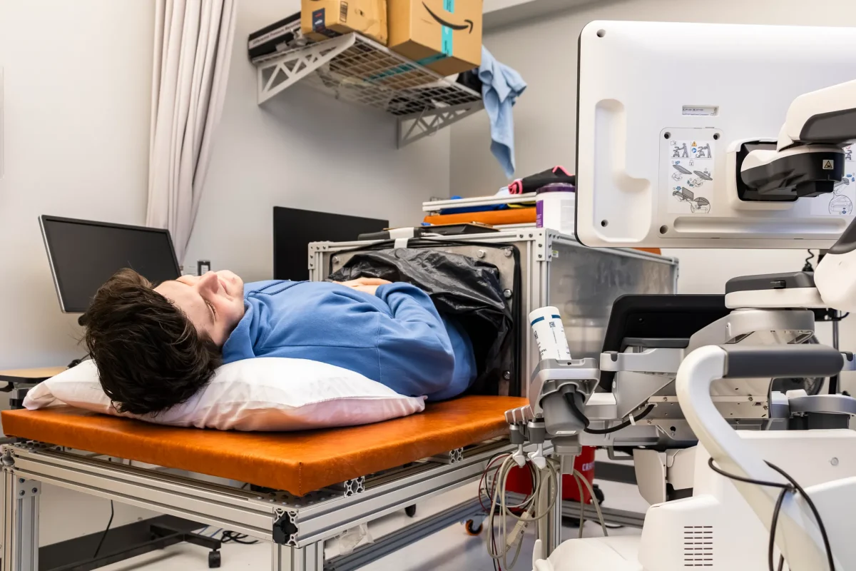A research team member demonstrates the vacuum box used for study.