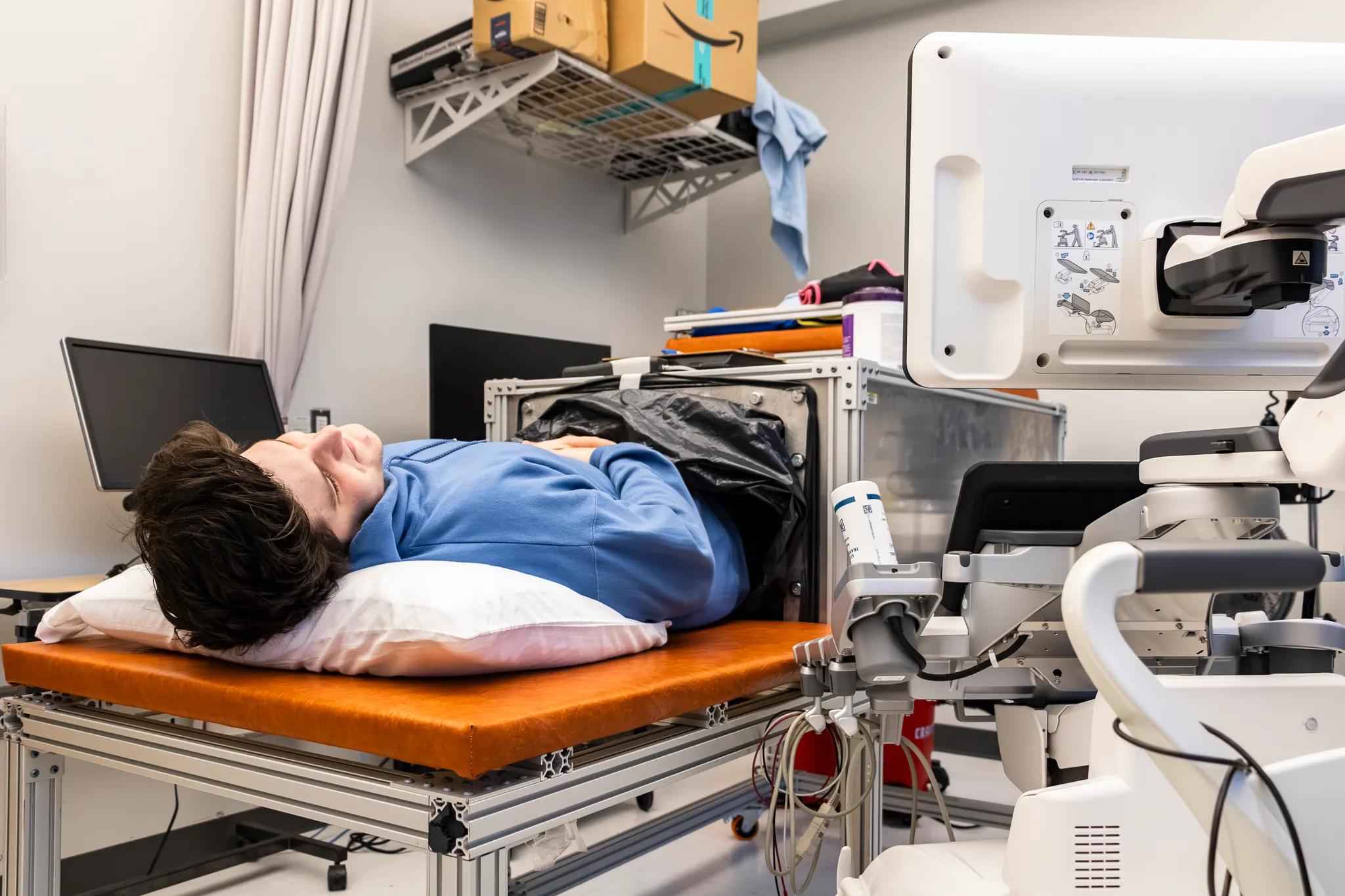 A research team member demonstrates the vacuum box used for study.