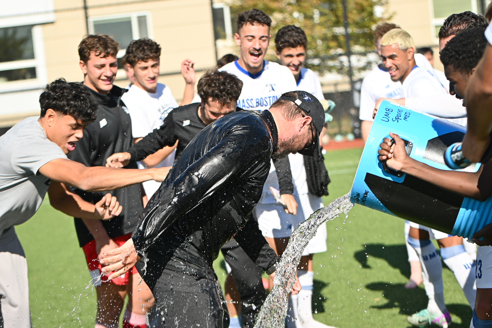The men’s soccer team erupted into celebration after their Oct. 18 win, dumping water over Jake Beverlin, who now holds the team’s career win record. Photo courtesy of Jonathan Malerba.