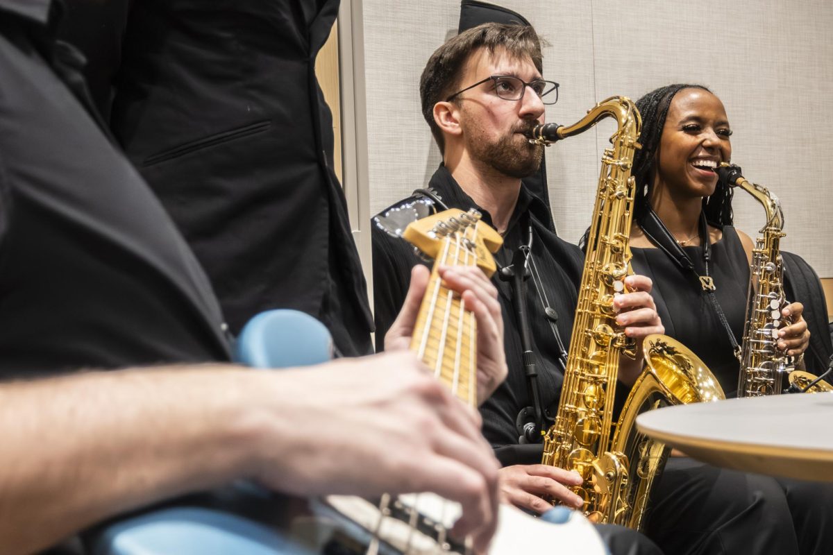 Jazz ensemble members socialize and practice ahead of the Jazz Night concert, Dec. 5.