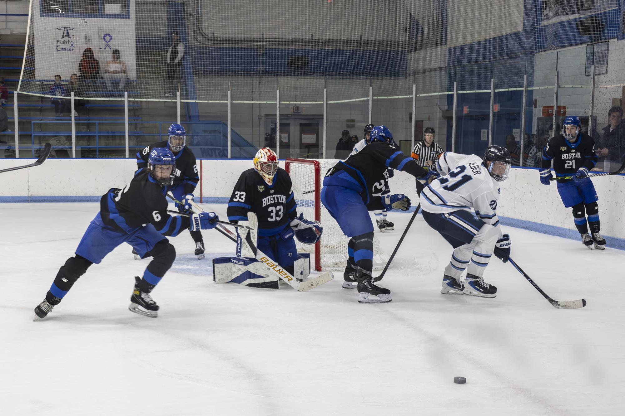 The Beacons battle for control of the puck with the Roger Williams University Swoops in their Dec. 6 home game. 
