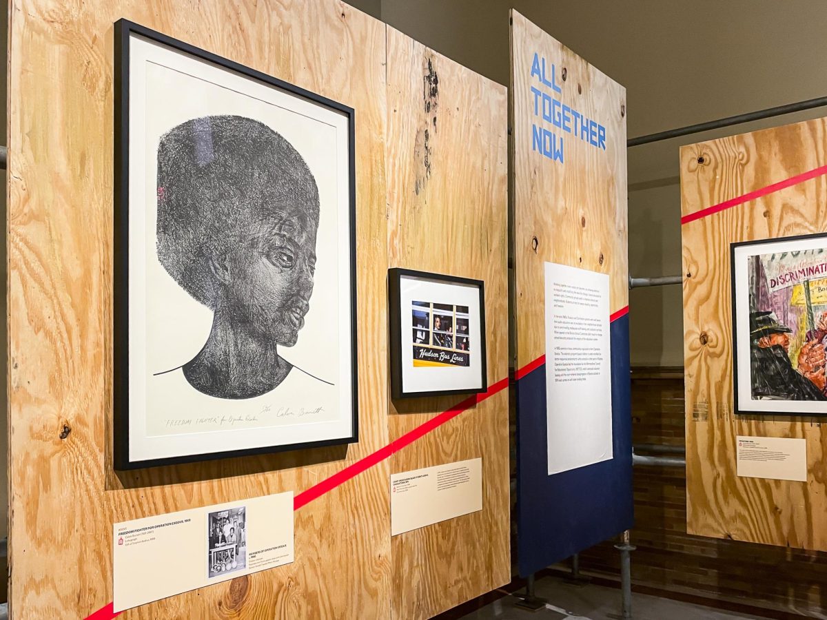 Calvin Burnett’s “Freedom Fighter for Operation Exodus” (Lithograph, 1969, Boston) hangs (left) in the “Revolution!” exhibition, Boston Public Library.