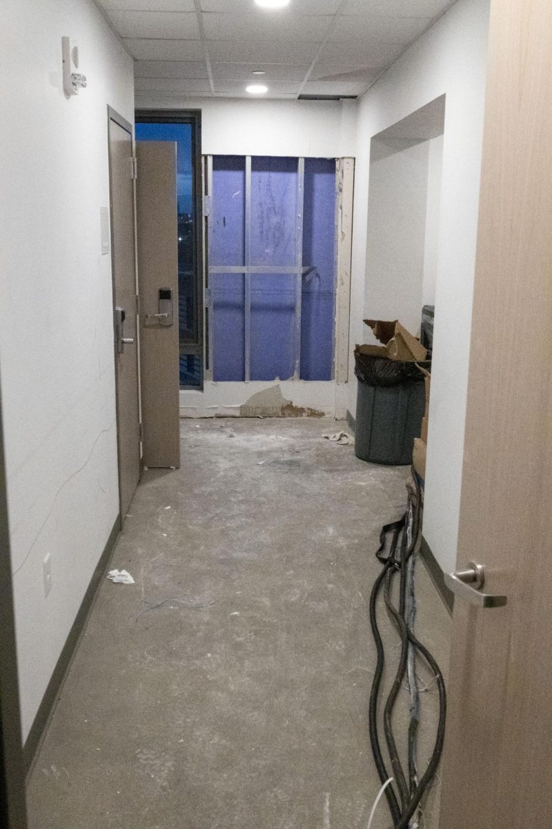 The trash room on the 9th floor, where crews removed drywall from an exterior wall. Ceiling tiles in the room showed signs of water damage. Electrical cables run to the hallway, where they power drying equipment.