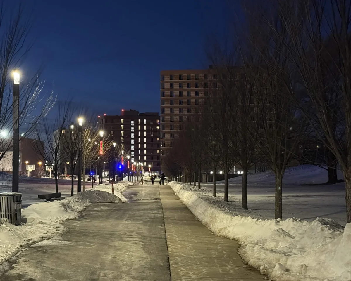 The East Residence hall, closed due to flooding, was dark Monday night as residents ate dinner and waited for shuttle buses at Campus Center. Behind, lights were on at the West Residence Hall, which is unaffected.