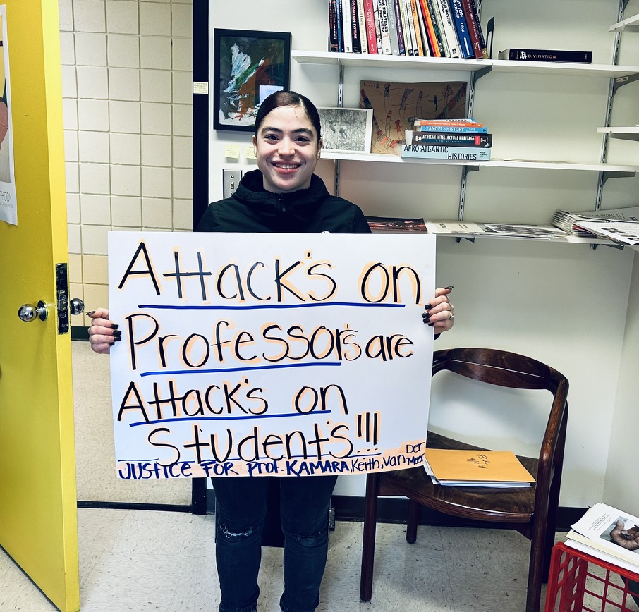 A student holds a sign protesting the university's treatment of the Africana studies department. Courtesy of Keith Jones