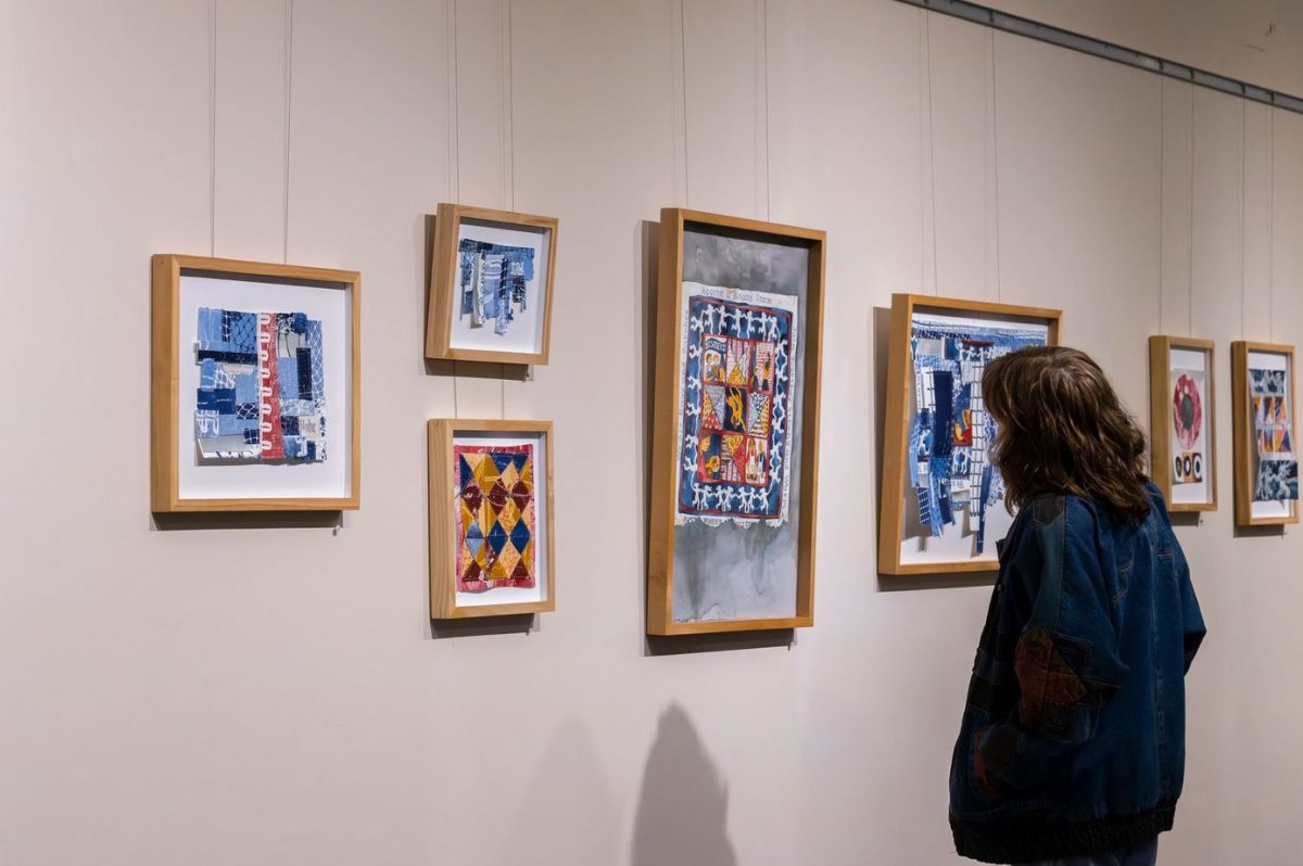 A student views the Grossmann Gallery on the 5th floor of the Healey Library.