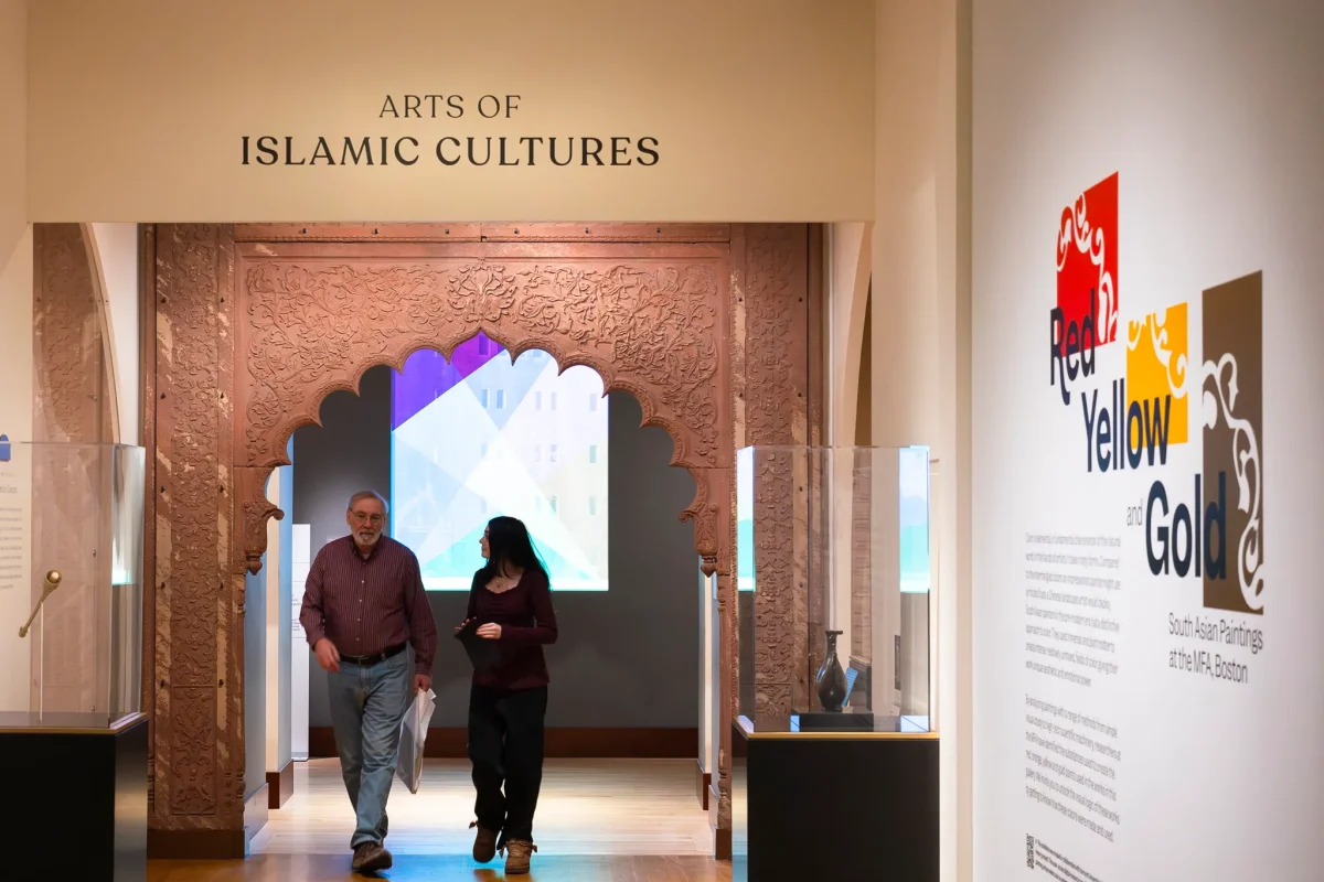 Museum-goers walk beneath an arch to an “Arts of Islamic Cultures” exhibit.